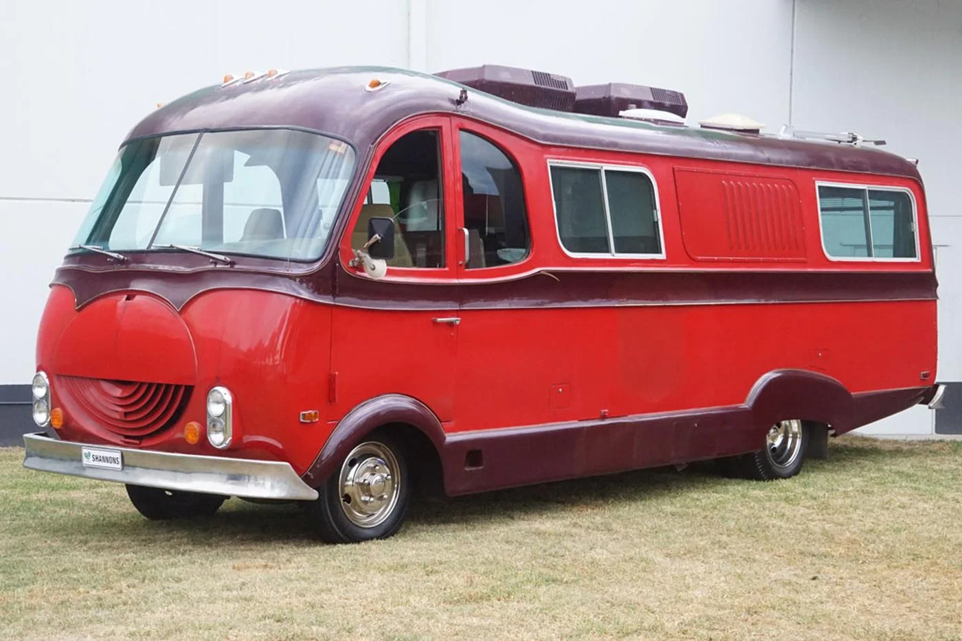 A surviving DayStar motor home in red and burgundy, showing the circular front grille and rounded cab